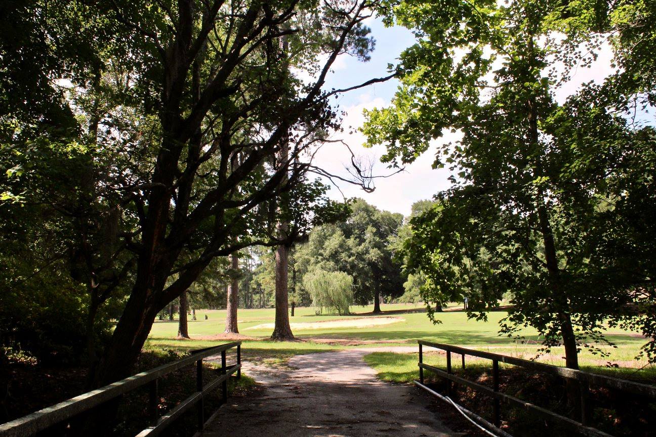 Small bridge leading through a wooded area onto the golf green at Darlington Country Club