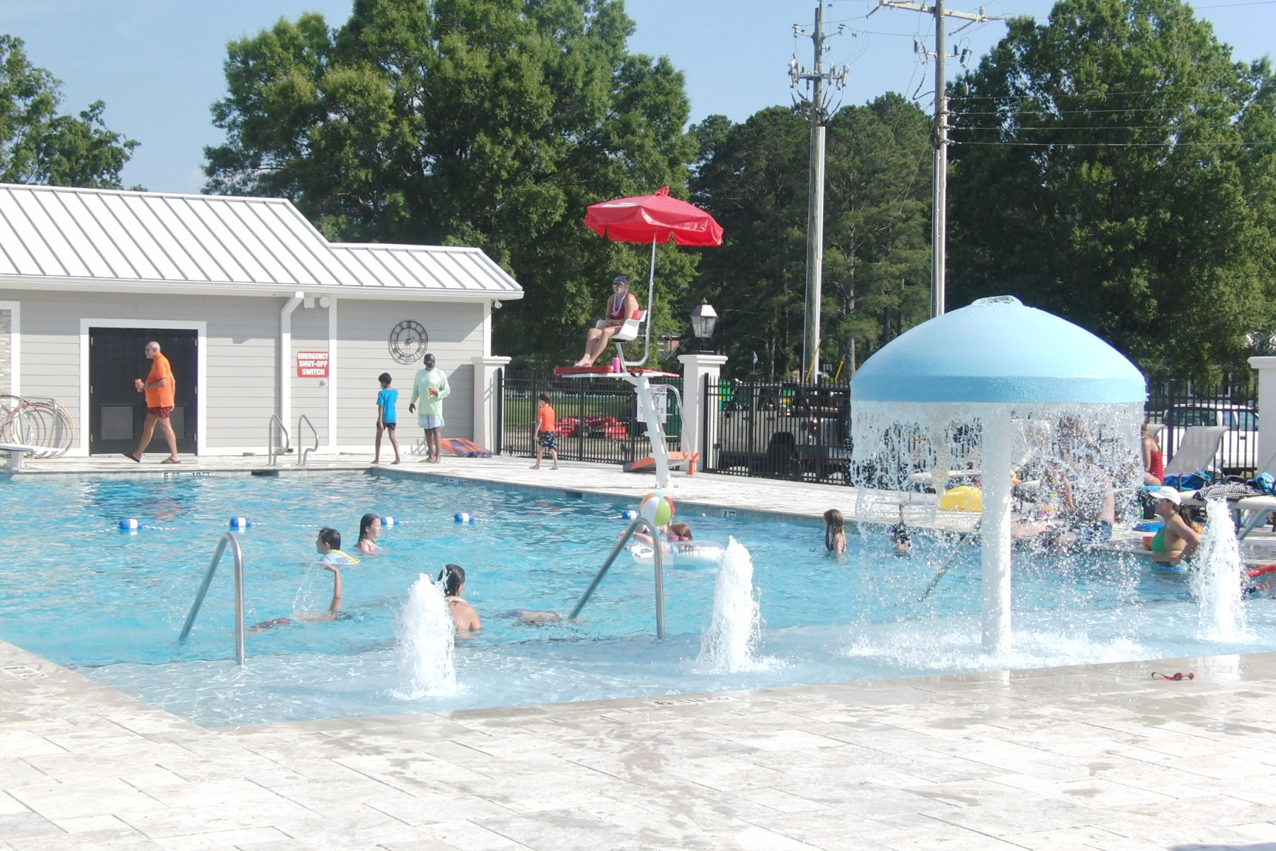 Children playing in the pool with a lifeguard on duty at Darlington Country Club